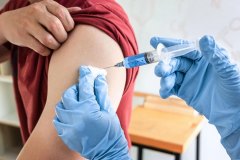 Doctor making a vaccination into patient with needle getting immune vaccine at arm for flu shot, coronavirus protective of epidemic